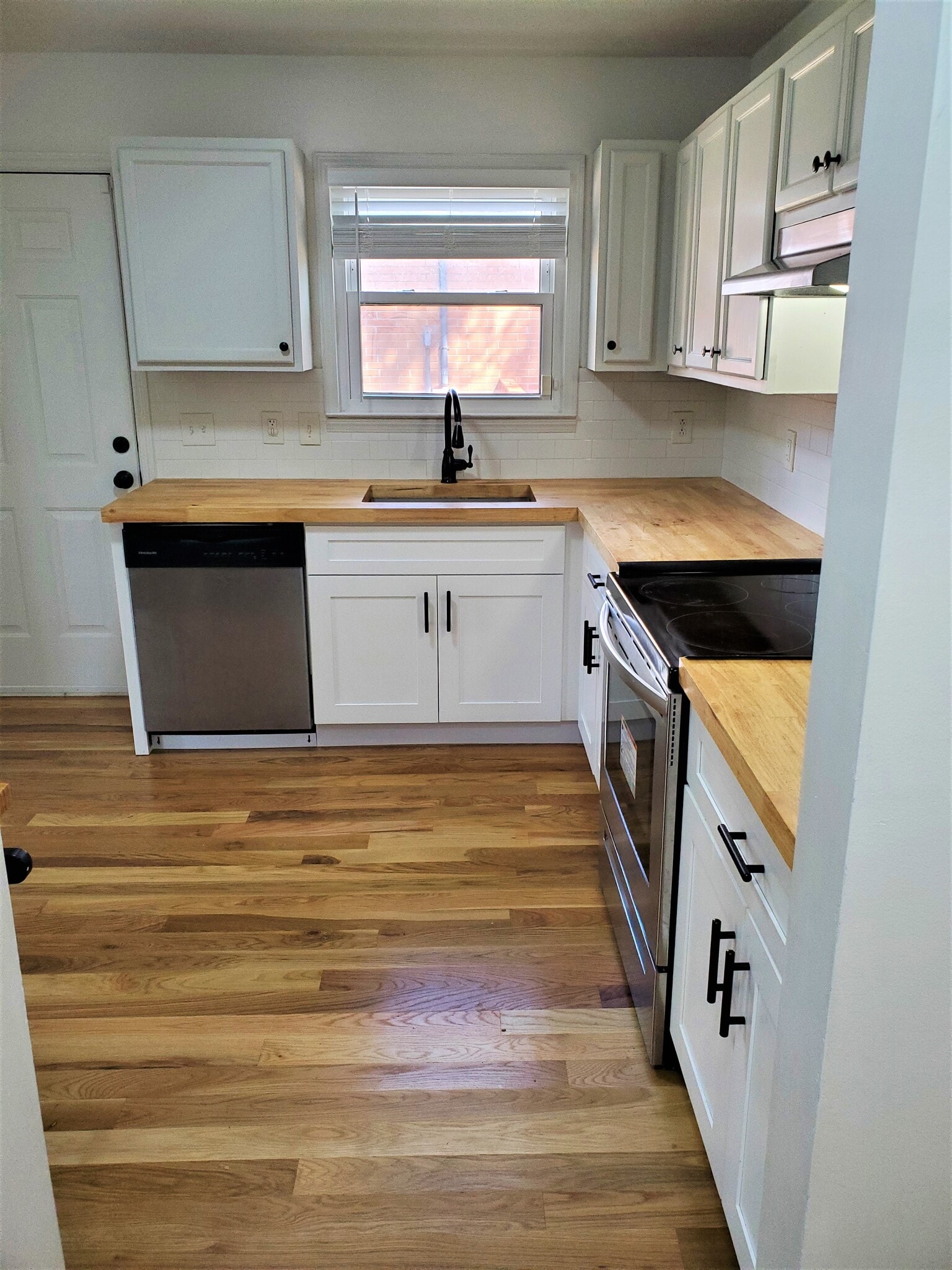 Kitchen overlooks side of the house, and provides a second door to access the back yard. - 1025 Wade Ave