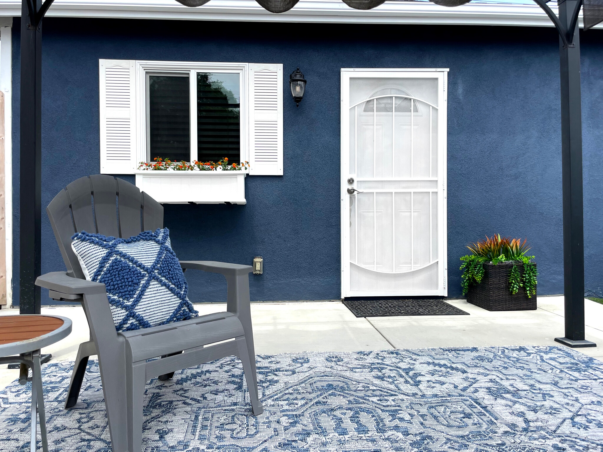 Sitting area with new rug under retractable pergola for shaded comfort - 3541 Helms Ave