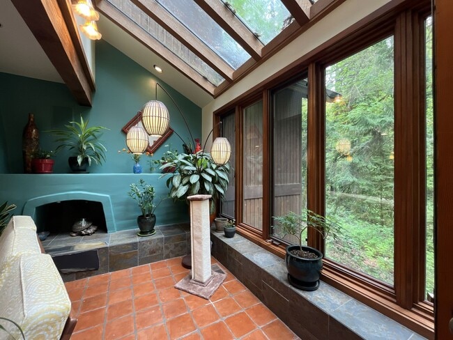 Building Photo - One-of-a-Kind Custom Home with Wall of Windows, Stone Fireplaces, Expansive Entertainment Space &...