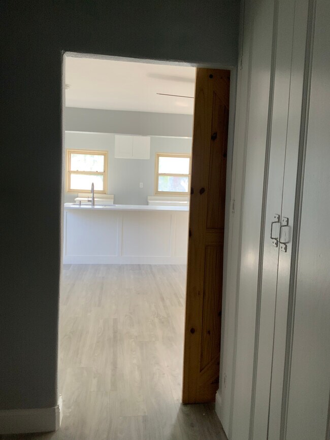 Bottom of staircase looking into living area/ kitchen - 3816 Byers Ave