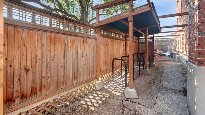 Outdoor covered bike parking located in secure back patio/garbage area - 1509 NE 10th Ave
