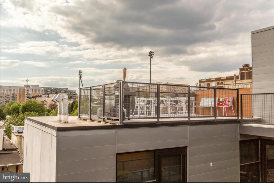 Rooftop patio with community grill and dining table - a shared common space. - 2250 11th St NW