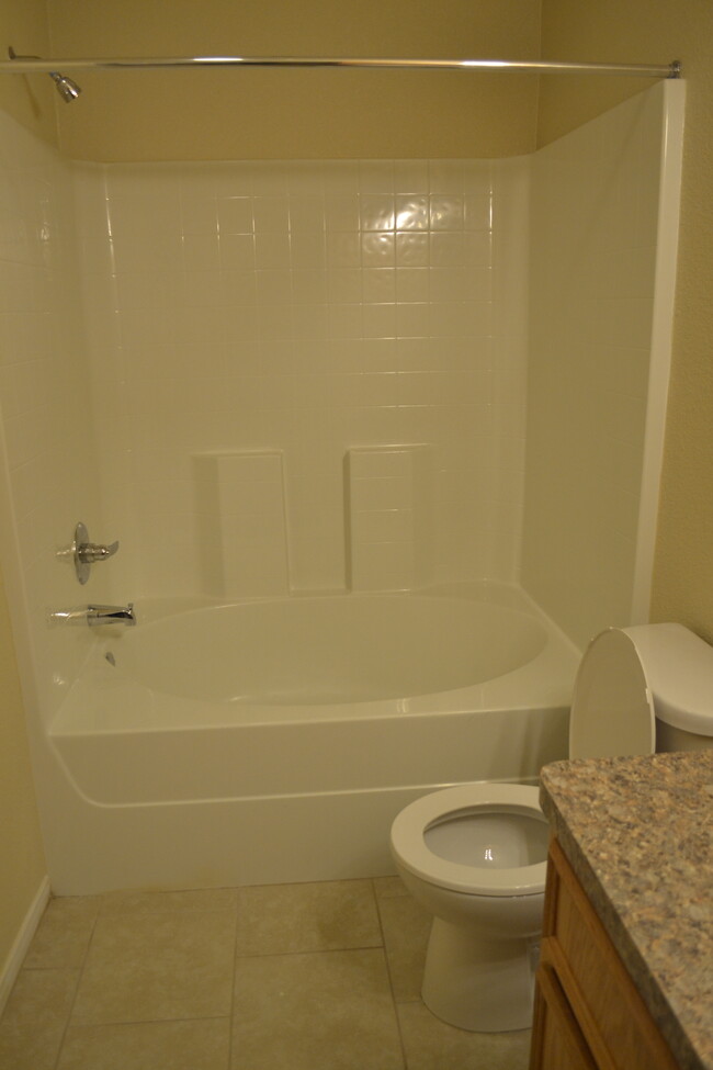 Master bathroom showing toilet and tub. - 220 Ryan Cir