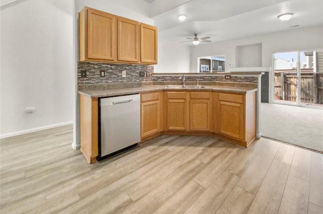 kitchen with dishwasher and bar - 14700 E 104th Ave