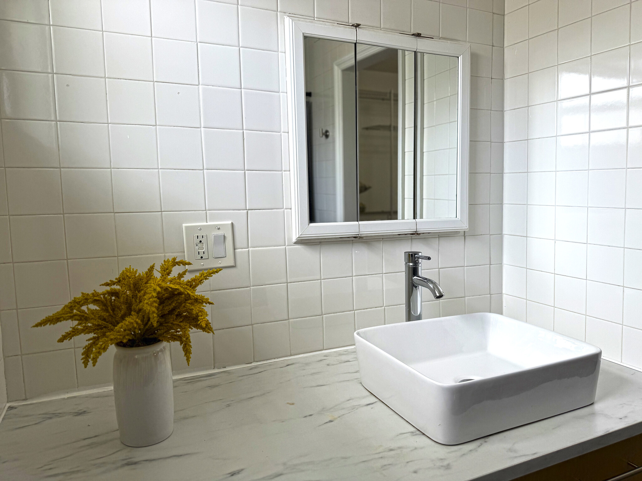 Bathroom vanity with all white tile - 630 NE 37th St