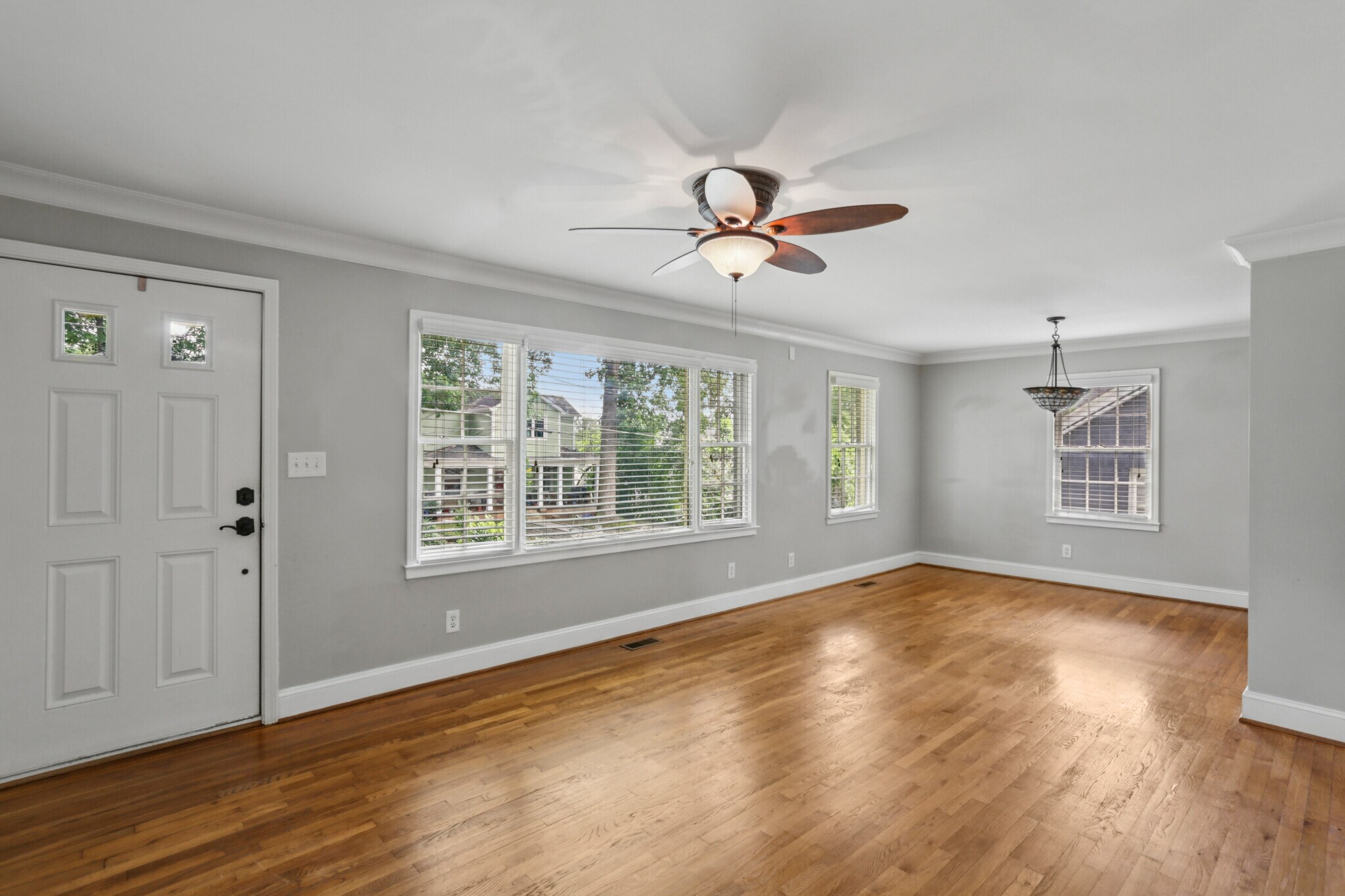 Living room with large windows and tons of natural light. Original hardwoods. - 781 Rosedale Ave SE