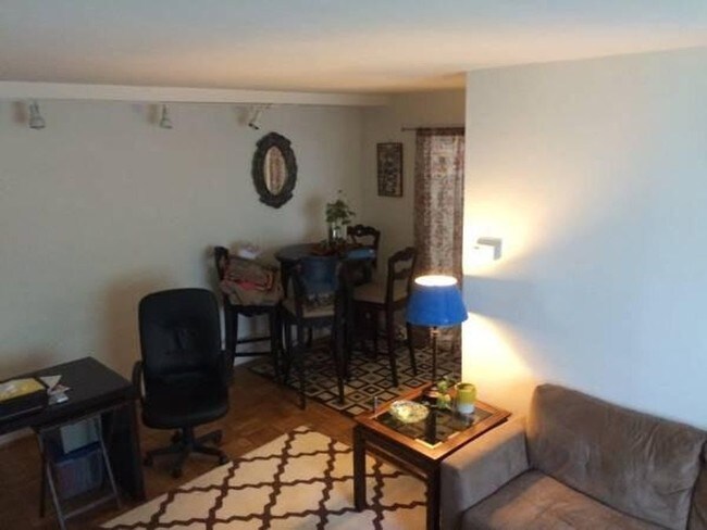 Main room with previous tenant furniture - 3829 Davis Pl NW