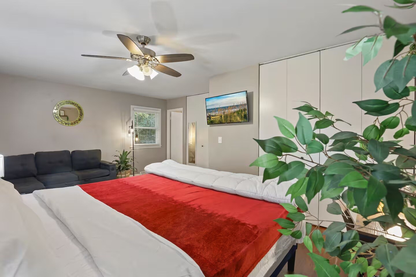 Bedroom 1 with king sized bed, sleeper couch, closet space and dedicated work table, chair and table - 1002 Juniper Ln