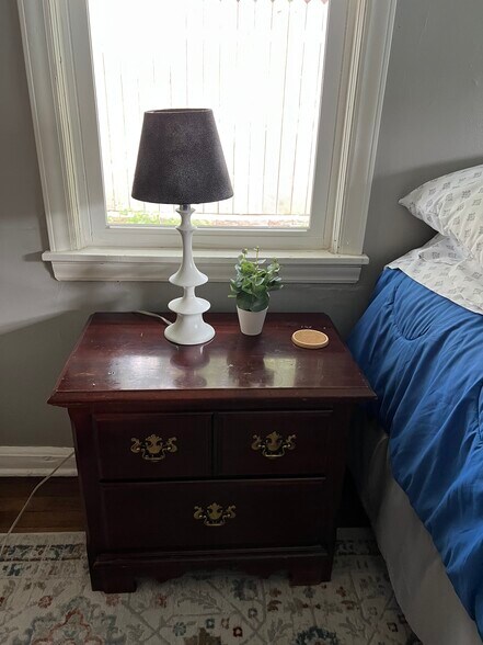 Night stand and lamp in bedroom - 4622 Cass St