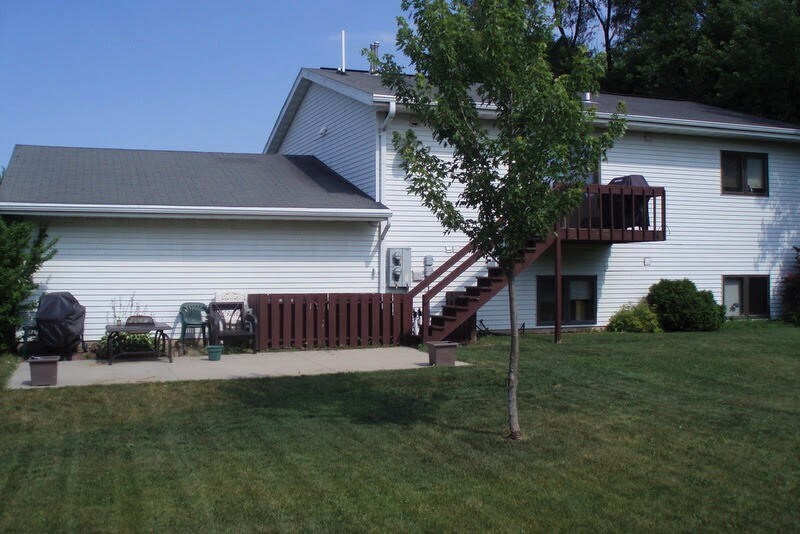 Balcony with stairs leads to cement patio and large back yard - 6157 S 42nd St