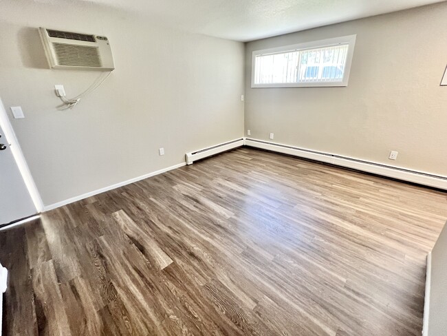Explore this inviting living area, bathed in natural light with sleek wood floors. - 591 West Prentice Avenue