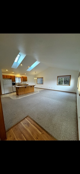 Open concept kitchen/living room with vaulted ceilings and skylights - 5446 NW Rhododendron St