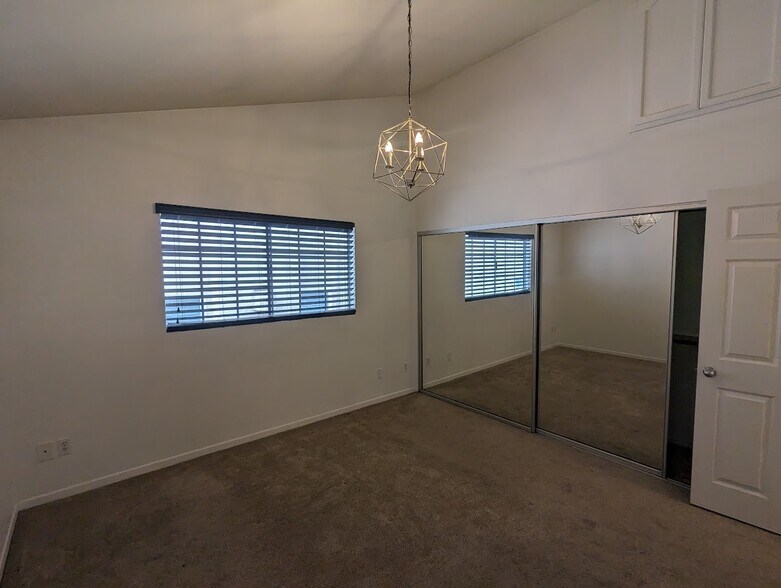 One of two upstairs bedrooms with high ceilings and extra storage space - 2474 S Centinela Ave