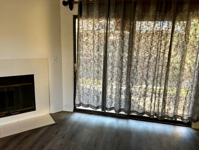Living room with balcony view - 10655 Lemon Ave