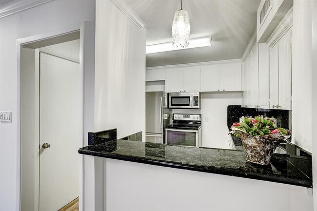 Building Photo - Beautifully remodeled two-story condo in a...