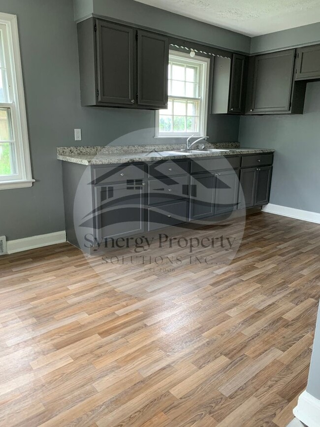Building Photo - Three bedroom fenced in yard one car attac...