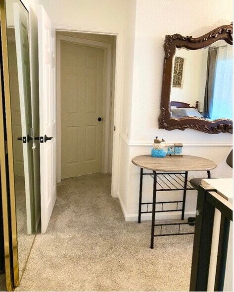 Small hallway from bedroom to bathroom. Carpeted room. - 372 Chaucer Dr