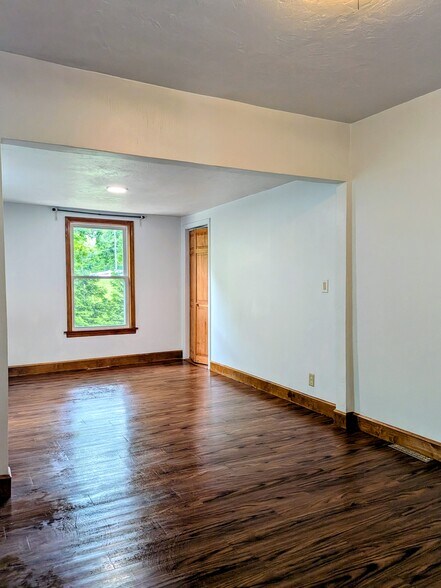 Bedroom 1- Oversized bedroom with plenty of windows and closet space. It can also fit a home office! - 1291 Main St