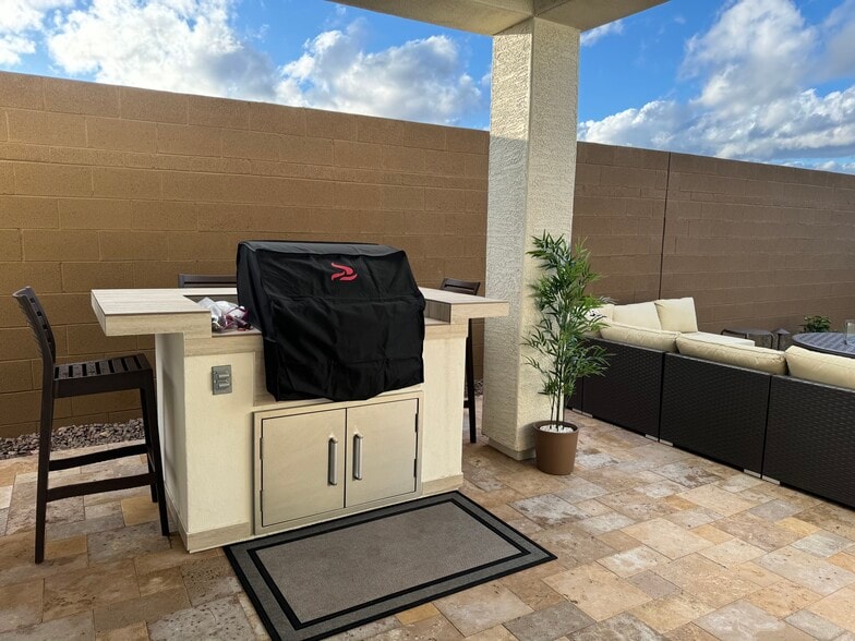 BBQ Island with bar seating for 4 and couch in background - 9052 W Georgia Ave