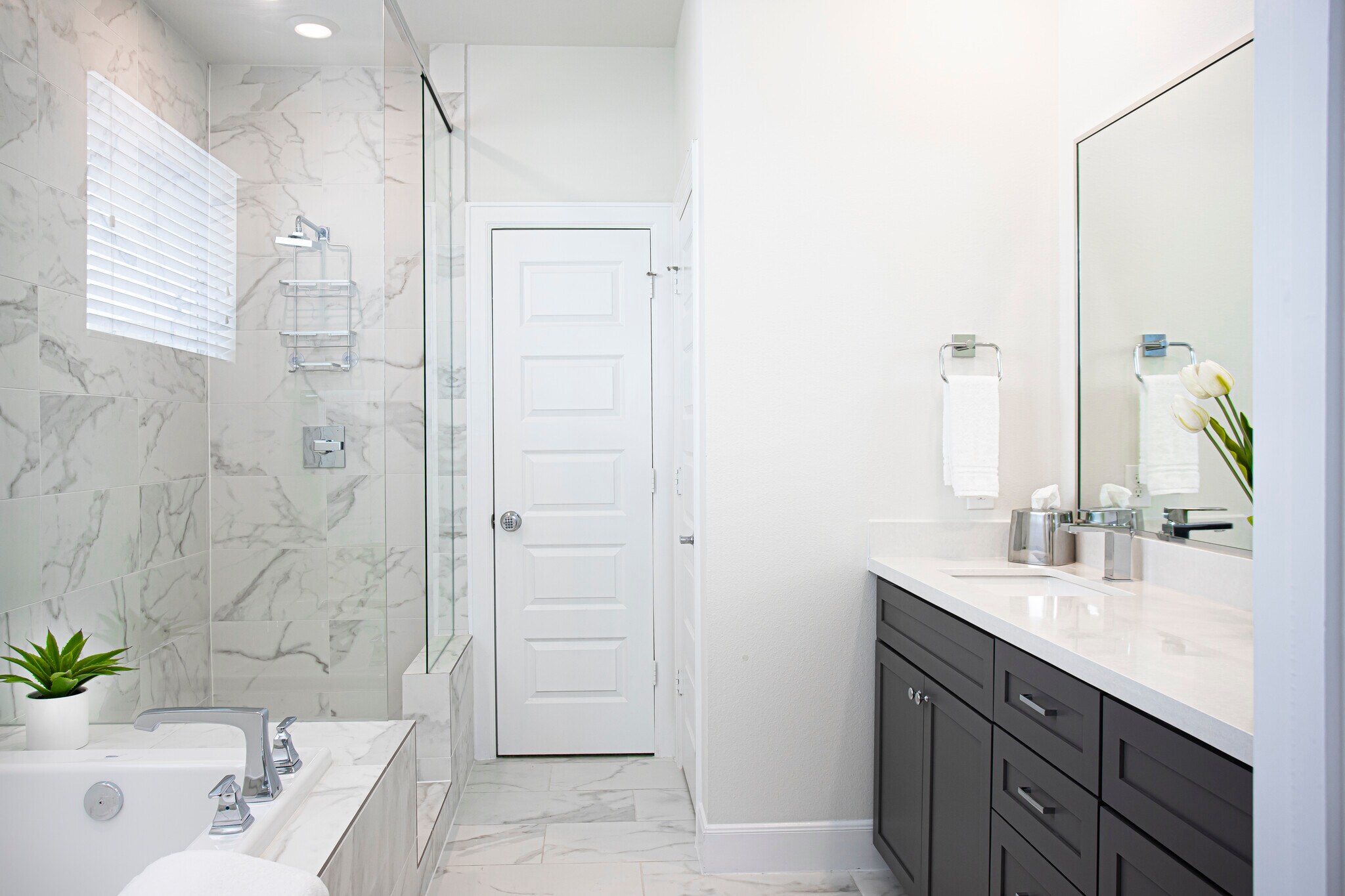 The ensuite bath features a separate shower. - 2713 Eado Edge Ct