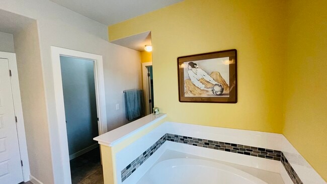 The shower is 3 feet wide and runs the length of the tub (it’s behind the yellow wall) - 7108 Garnet Mill Ln