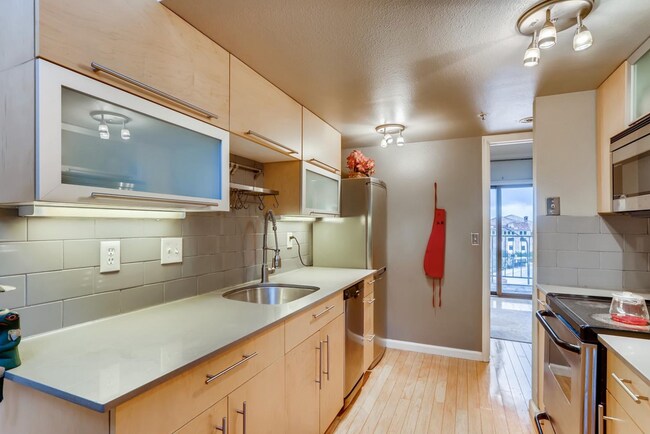 Kitchen with view towards main floor bedroom - 1085 Broadway St