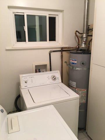 View of washing machine + hot water heater. - 60 Cold Springs Rd, Apt
