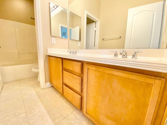 Building Photo - THIS SPACIOUS RESIDENCE FEATURES 4 BEDROOM...