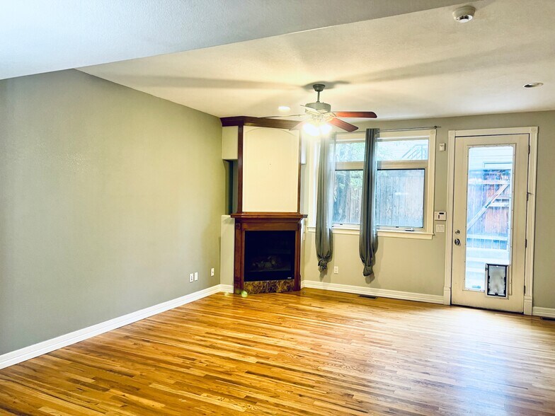 Living room with gas fire place and leads out to a back patio - 2317 Decatur St