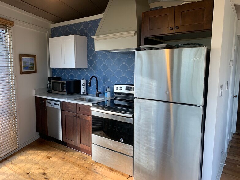 Kitchen features full size fridge, oven, dishwasher, microwave, coffee pot and prep area - 149 Treetop Knl Dr