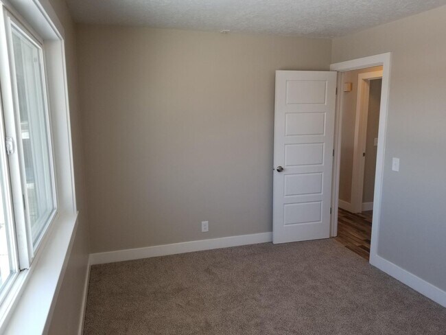 Building Photo - Spacious 5-Bedroom Magna Home with Deck and Ample Parking