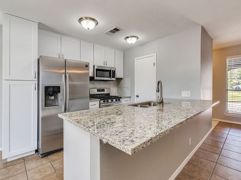 kitchen with stainless steel appliances - 7308 Grand Canyon Dr