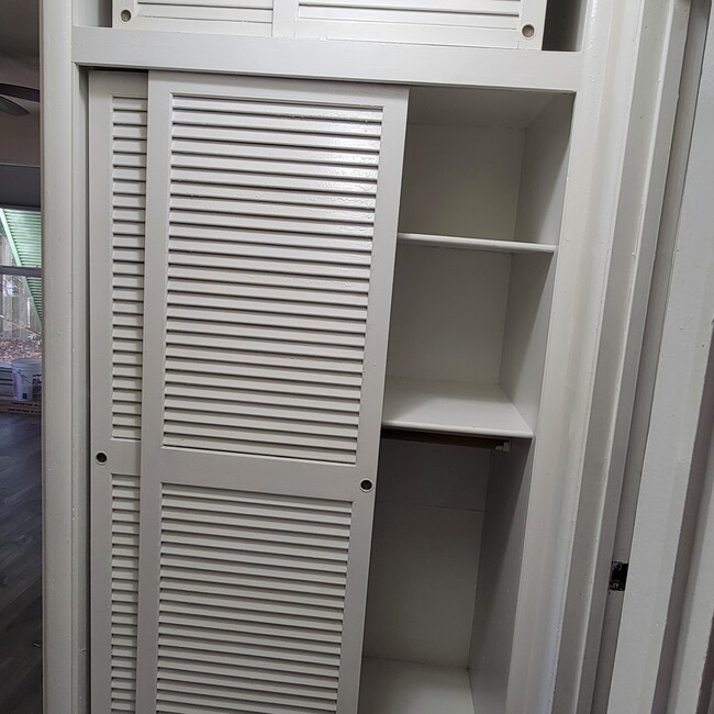 large linen closet with overhead storage - 2031 NE 56th St