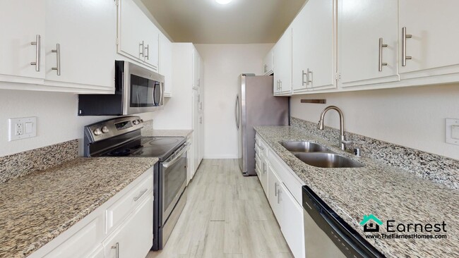 Primary Photo - 2 + 2 Spacious 2-Bedroom Condo with Top-Ti...