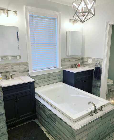 Upstairs full bath with two sinks, soaking tub, and private toilet room. - 74 Peters Pl