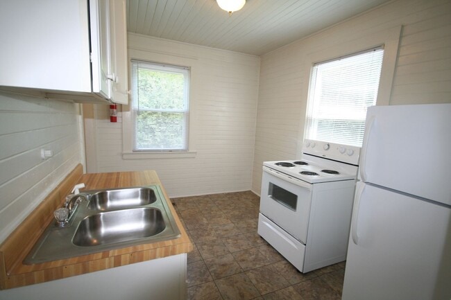 Building Photo - Walltown duplex with gleaming floors, a front porch, and a large pantry — all under $1,300.