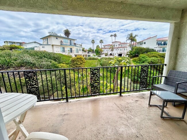 Building Photo - Steps to the beach from this Ocean View Condo with 2 car garage