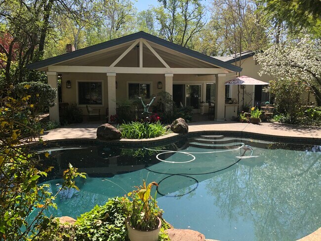 Backyard patio, lush grounds and in-ground pool & spa - 5930 Long Acres Ct