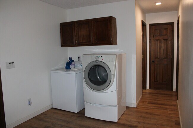 Laundry Area near Linen Closet and Main Level Full Bathroom - 2115 Pineshore Ct