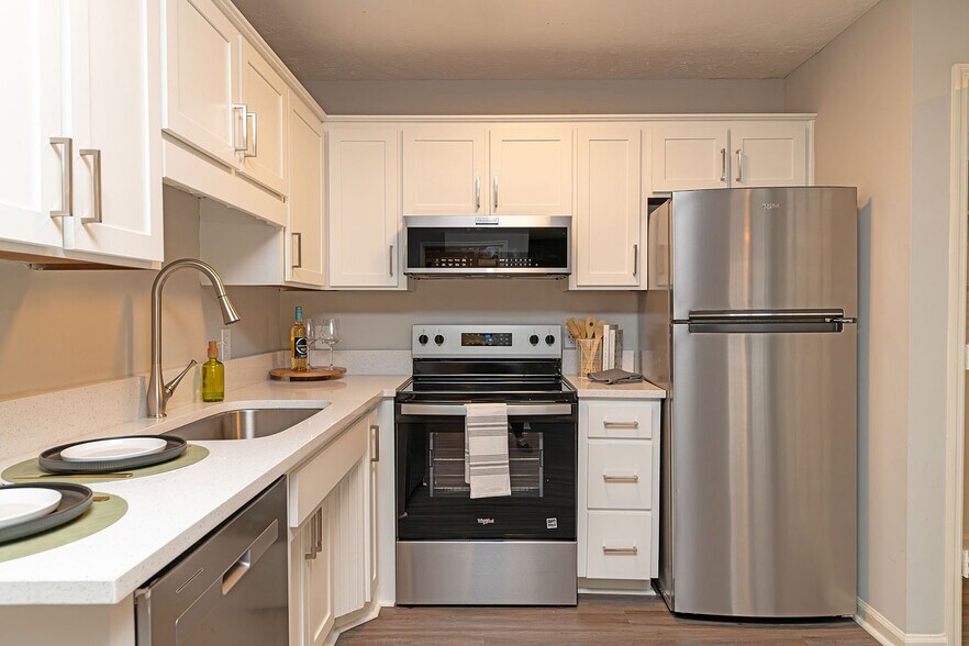 Kitchen with quartz counters, stainless appliances, and modern cabinetry - Vetra Providence