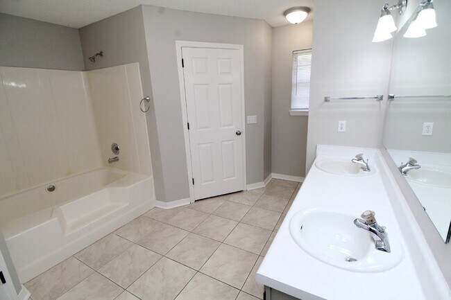 Building Photo - West Pensacola Brick Home with Vaulted Ceilings, Split Floor Plan, Open Living Design & Easy Acce...