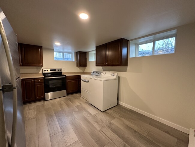 Kitchen with included washer/dryer and new stainless steel applicances - 1137 E Platte Ave