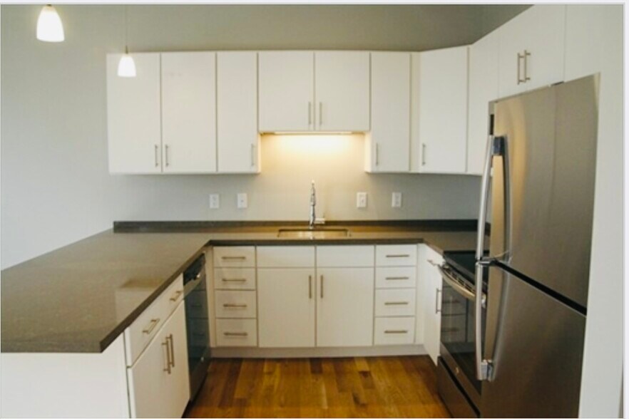 White cabinets, stone counters, stainless-steel appliances - 20 Orleans St