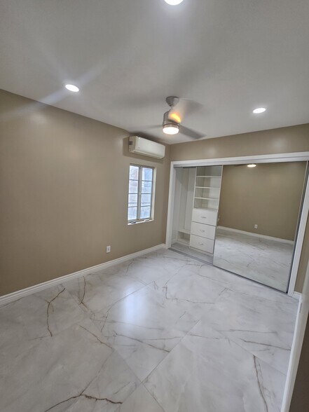 Bedroom 1. Wall closet with shelves, ceiling fan, backyard view, private bathroom. - 918 E Elk Ave