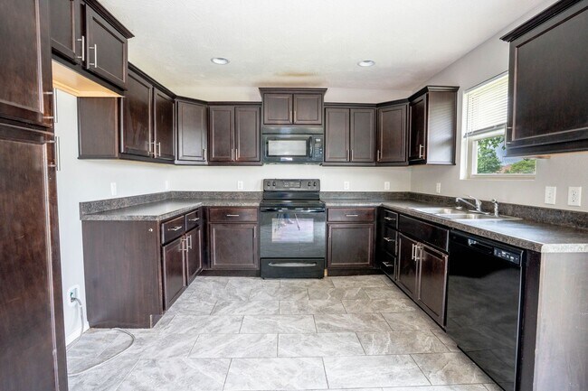 Building Photo - 3 bed home with NEW FLOORING AND FULLY FEN...