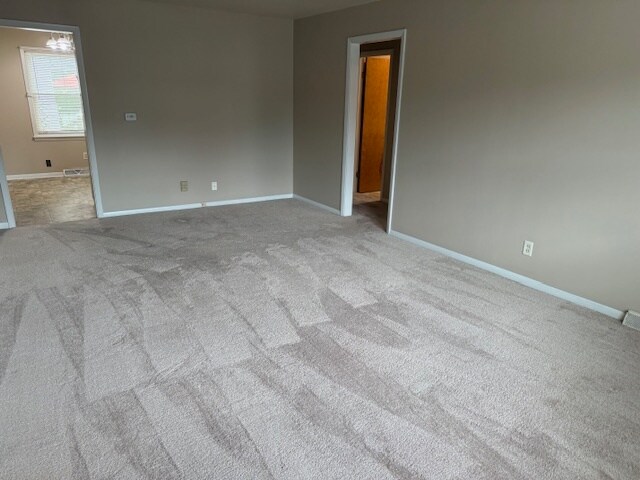 Living Room. Like unit. Unit available has manufactured plank flooring. - 1118 E Washington St