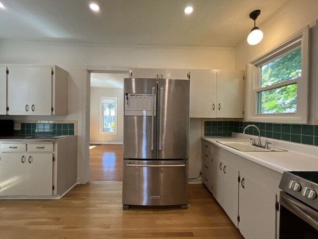 Building Photo - Charming Cottage with Hardwood Flooring, Modern Kitchen & Beautiful Outdoor Living Areas