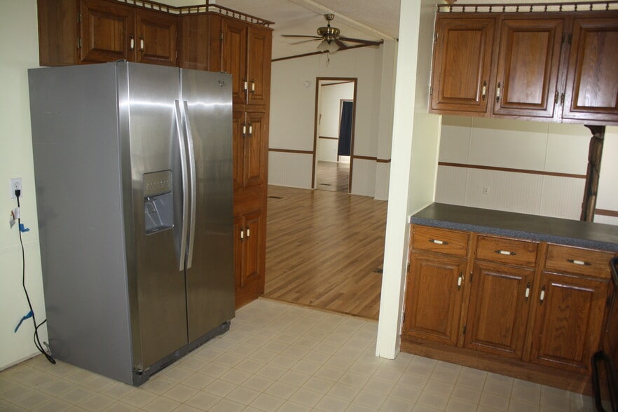 kitchen includes side-by-side refrigerator - 3305 Peaceway Dr