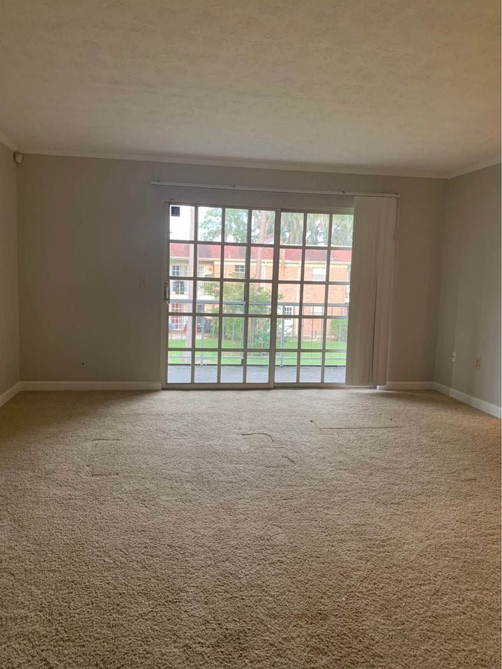 Living Room and balcony is outside sliding glass doors overlooking courtyard. - 5201 ATLANTIC Blvd