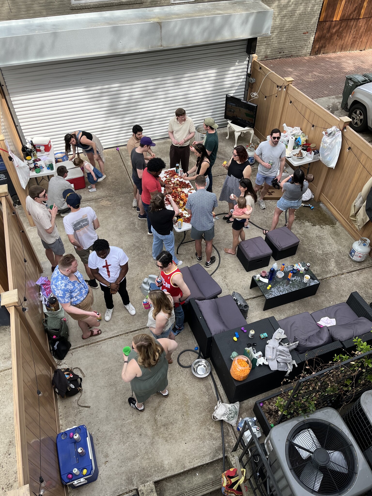 Back patio space with furniture set up (and people and a crawfish boil) - 655 16th St NE